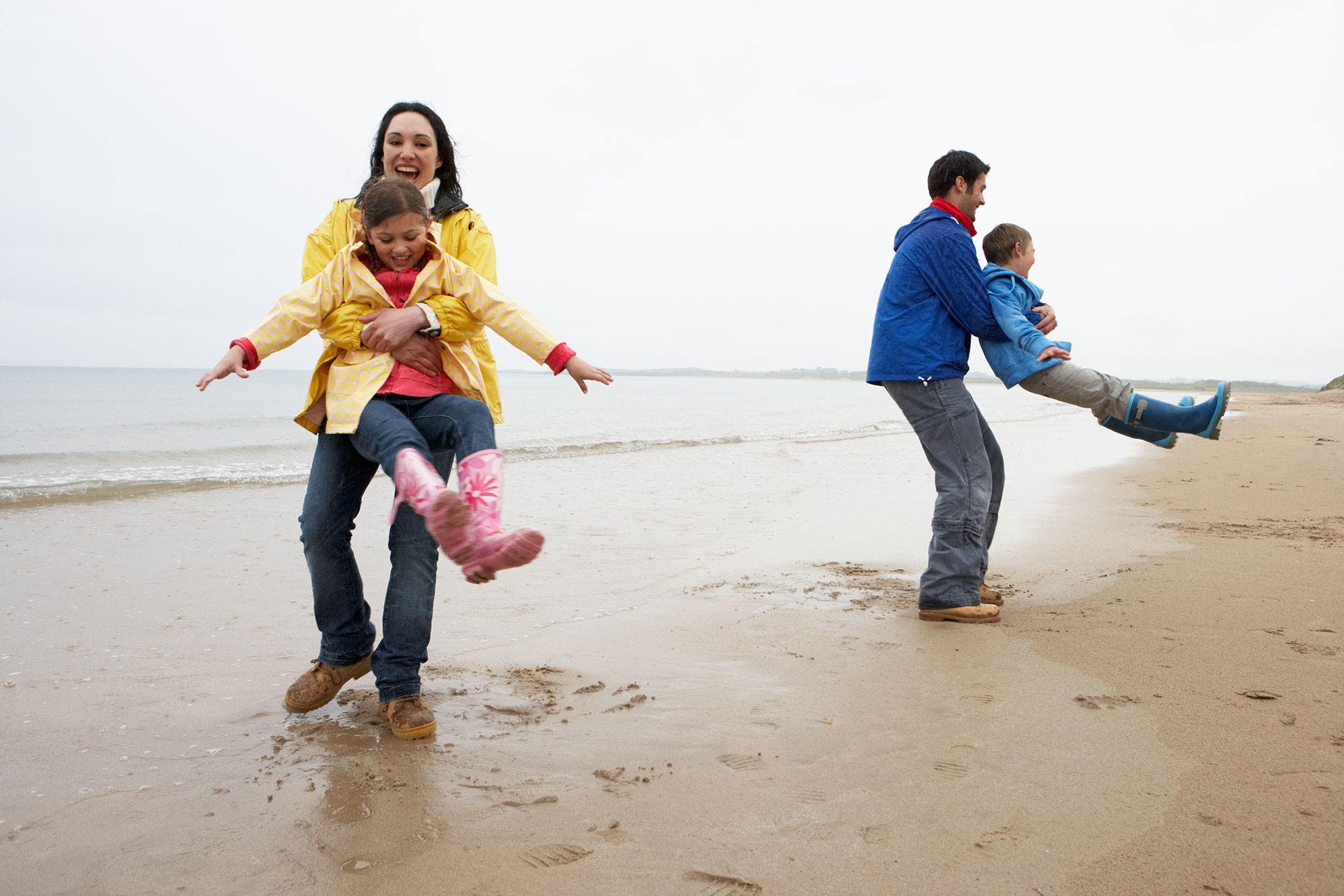 Family Playing in the rain on the Beach