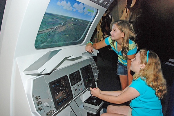 Two girls check out an exhibit at the Kennedy Space Center Visitor Complex