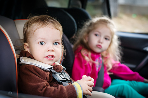 Little Boy and Girl in Backseat of Car