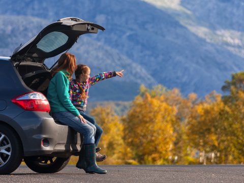 Mother and Daughter in SUV in Mountains; Courtesy of Mostovyi Sergii Igorevich/Shutterstock.com