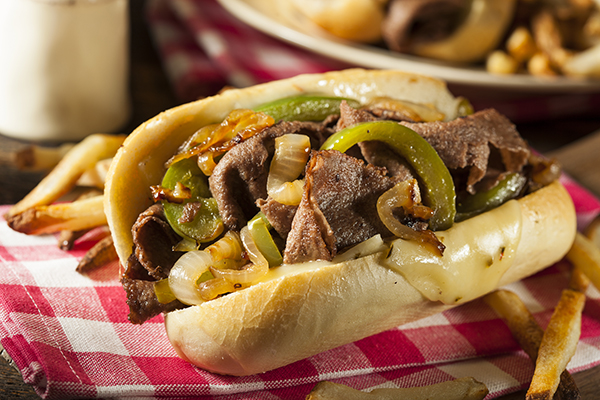 The original Philly cheesesteak is loaded up with onions, peppers, and rib-eye steak; Courtesy of Brent Hofacker/Shutterstock.com Continue your famous foods in the US tour with a classic Philly cheesesteak.