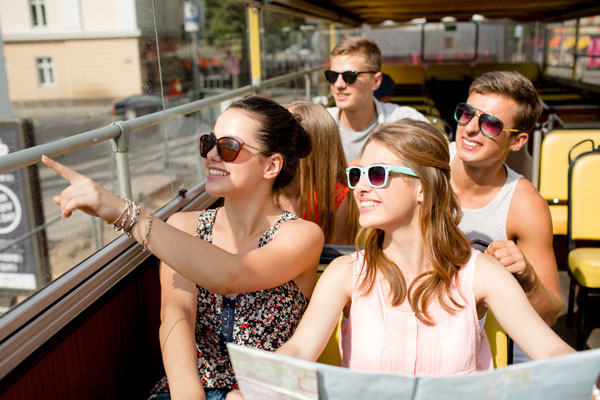 Teens traveling around on a tour bus.