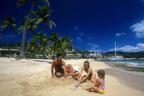 A family playing on the beach at Bolongo Bay Beach Resort in St. Thomas.