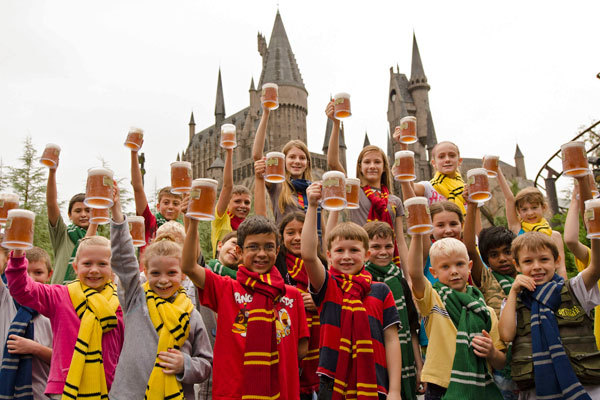 A group of kids drinking butterbeer at The Wizarding World of Harry Potter in Orlando, Florida.