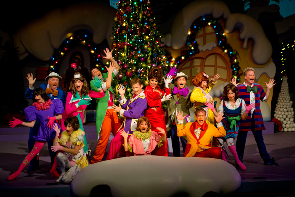 The Grinch and Whoville characters enjoying their Wholiday; Courtesy of Universal Studios Orlando The Grinch and Whoville characters pose in front of a Christmas tree.