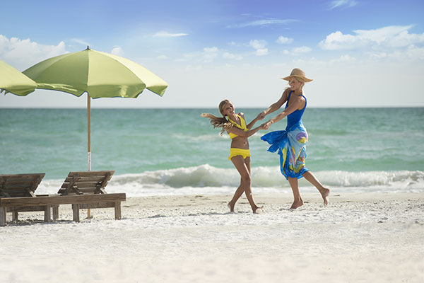 A mother and daughter playing on the beach at The Resort at Longboat Key Club in Florida.