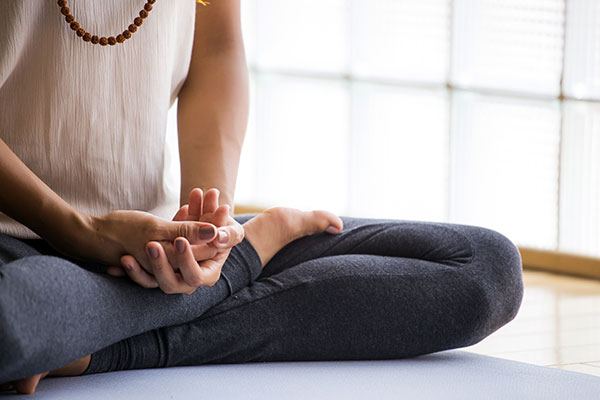 A woman meditating.