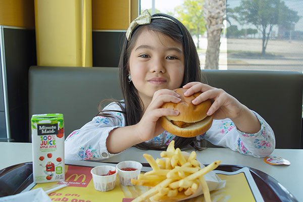 A little girl about to dive into her McDonald's Happy Meal.