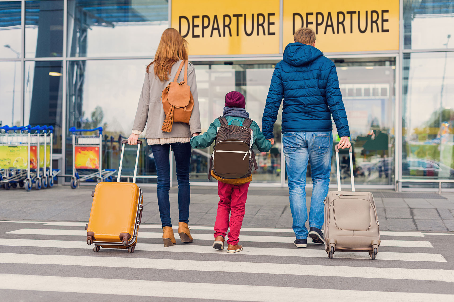 A family headed into the airport to catch a flight.