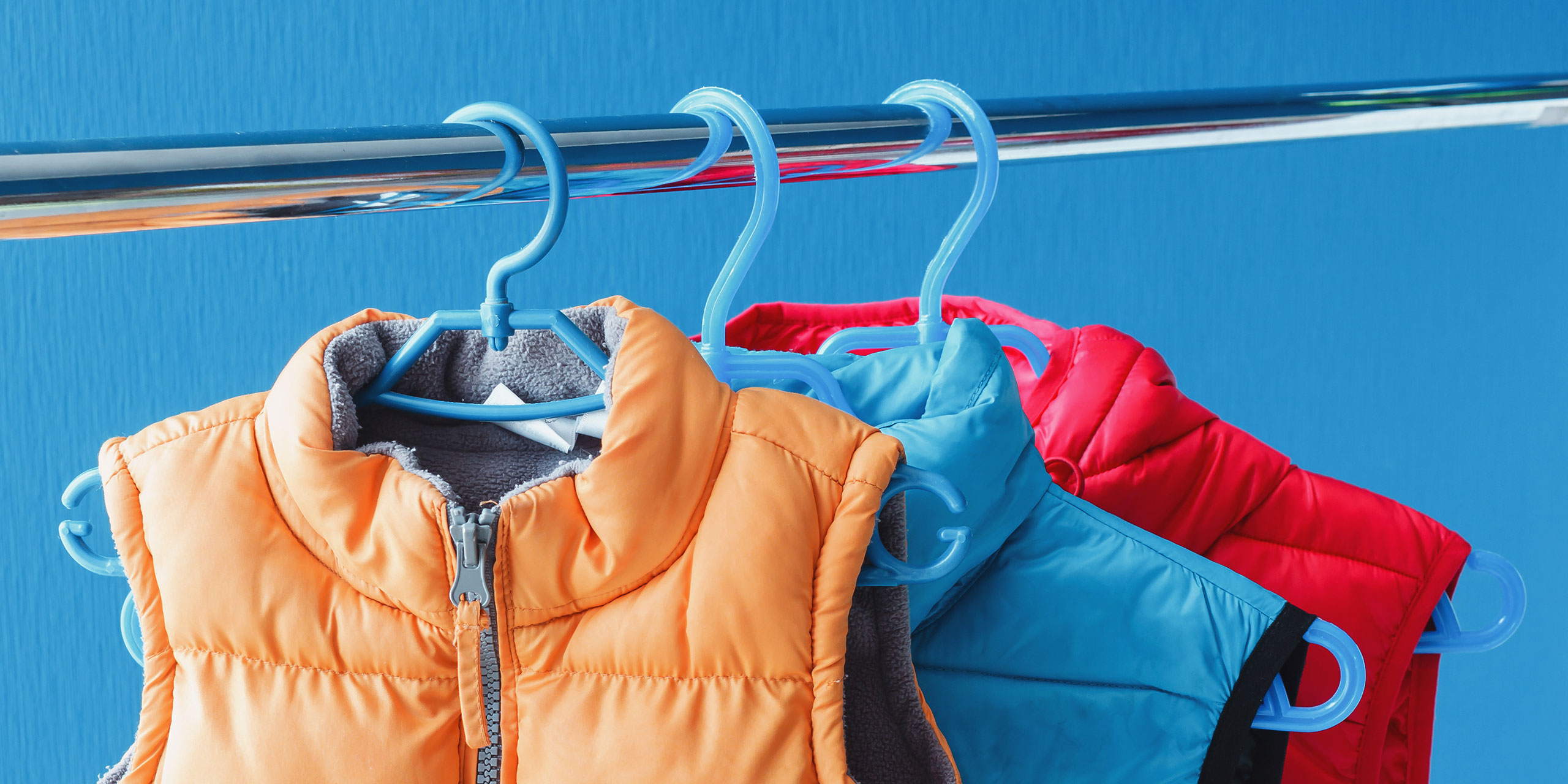 Winter Vests Hanging in a Closet; Courtesy of PicMy/Shutterstock