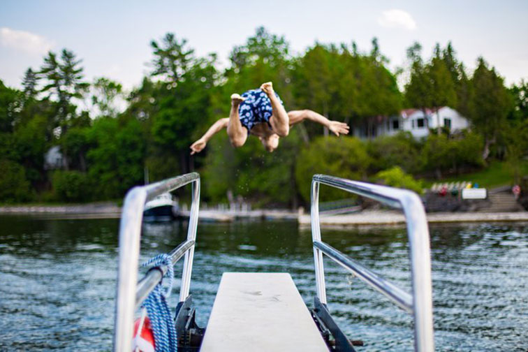 Boy Jumping in Lake at Basin Harbor Resort in Vergennes, Vermont