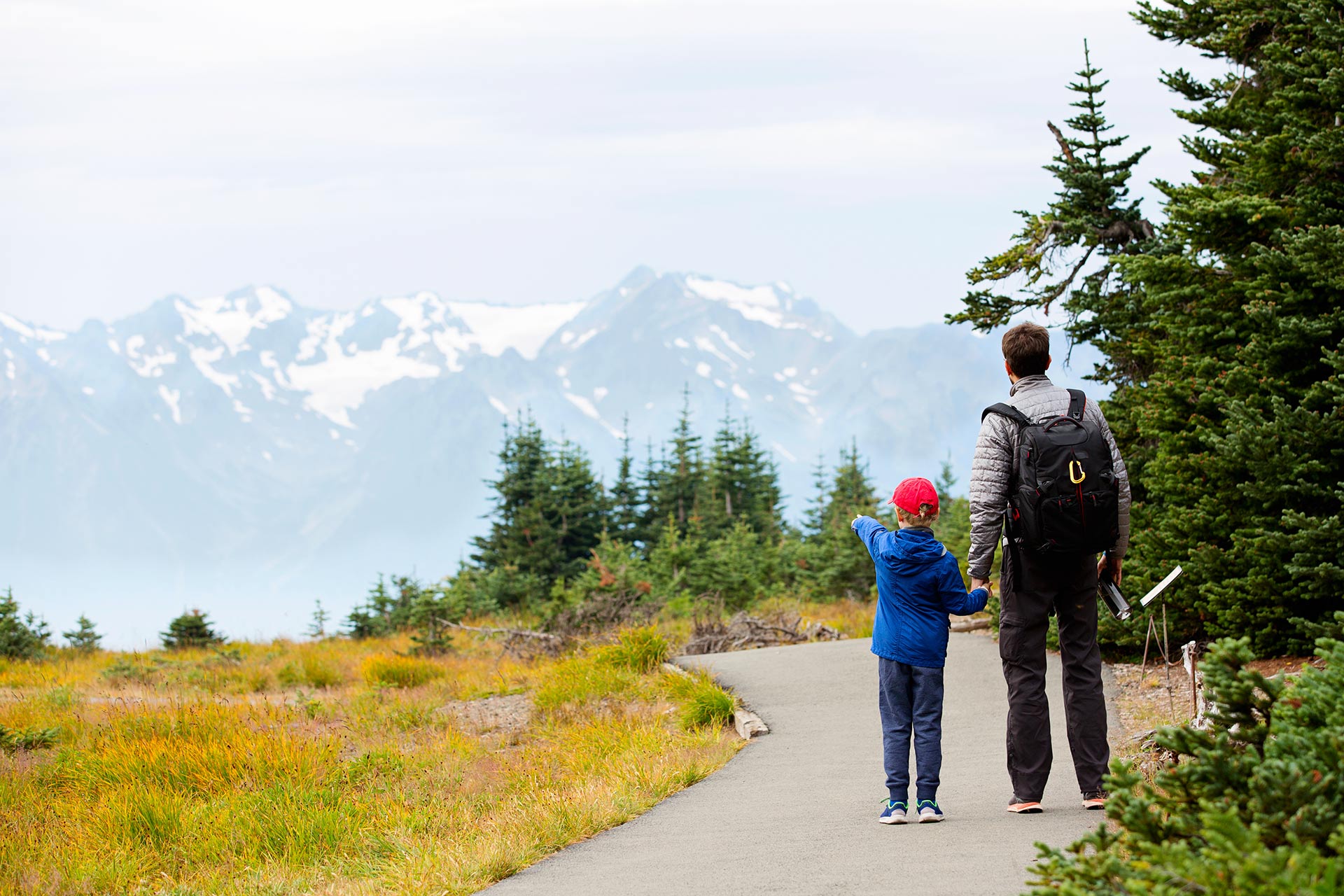 A father and son taking in the beautiful views at Olympic National Park in Washington.