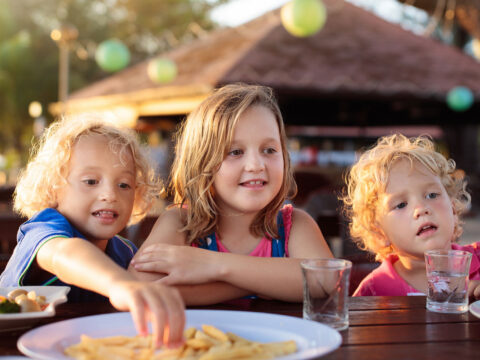Kids Eating at Resort; Courtesy of FamVeld/Shutterstock.com