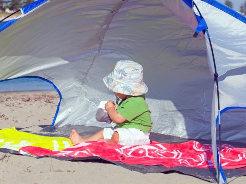 Baby In Beach Tent; Courtesy of Marcella Miriello/Shutterstock.com