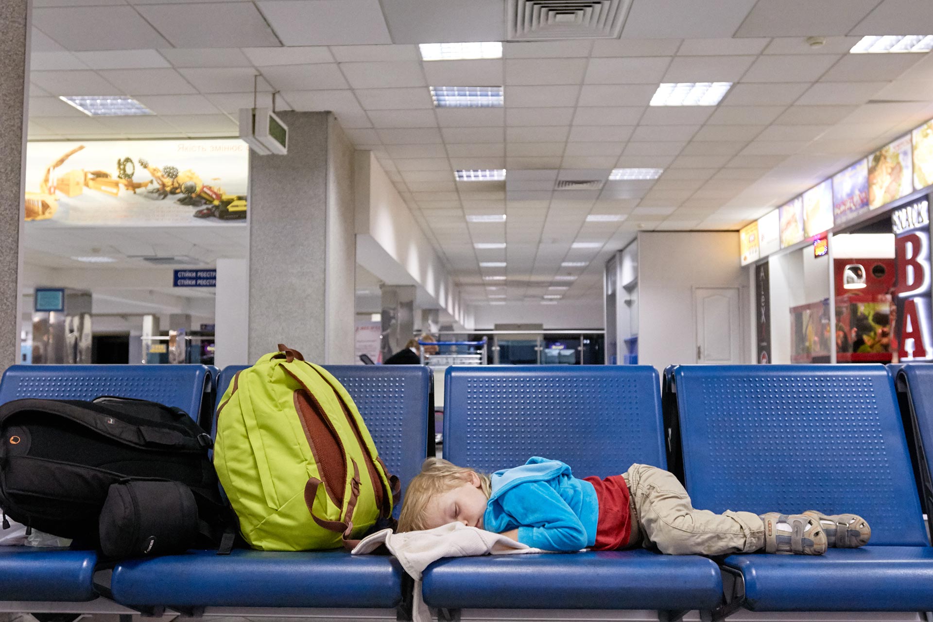 Tired little boy sleeping in the airport