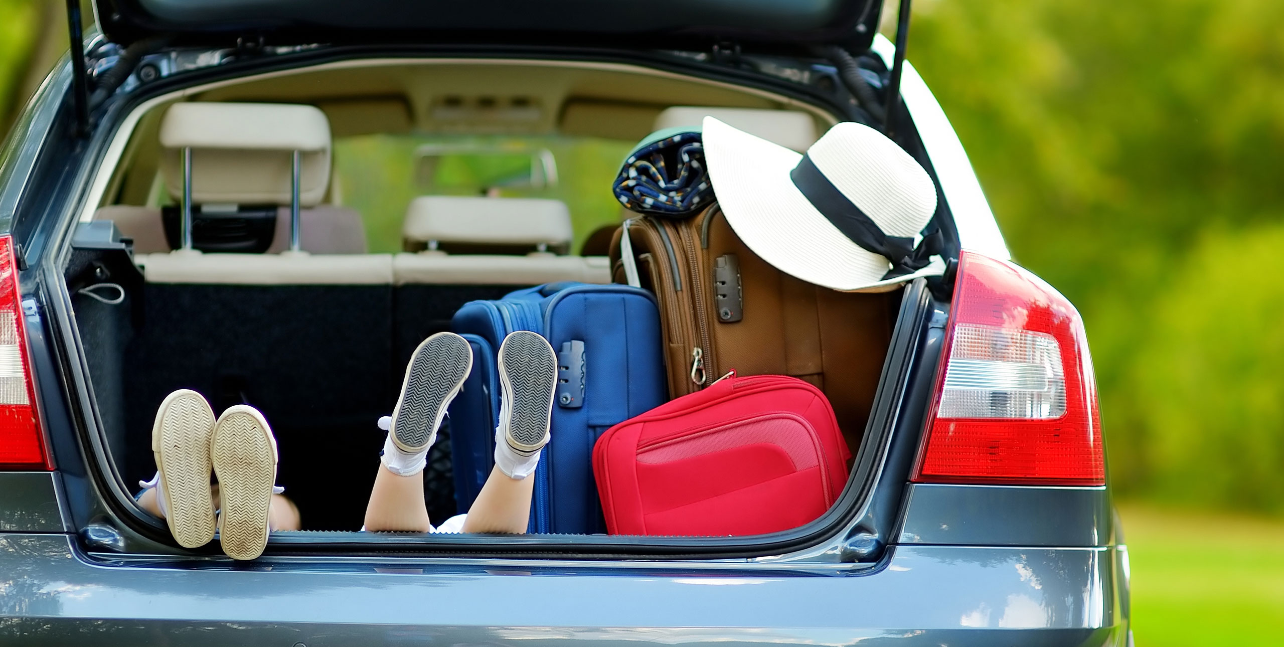 Bags and Kids in Trunk of Car; Courtesy of MN Studio/Shutterstock.com