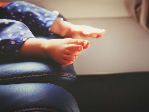Baby Feet On Plane; Courtesy of NadyaEugene/Shutterstock.com