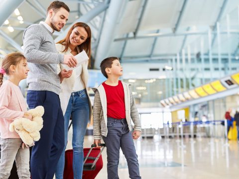 Family Standing in Airport; Courtesy of Robert Kneschke/Shutterstock.com
