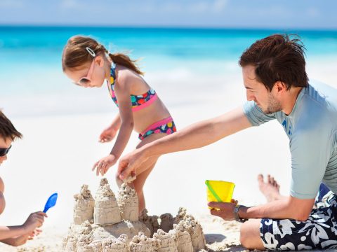 Dad Playing On Beach; Courtesy of BlueOrange Studio/Shutterstock.com