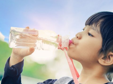 Girl Drinking Water Bottle; Courtesy of Casezy idea/Shutterstock.com