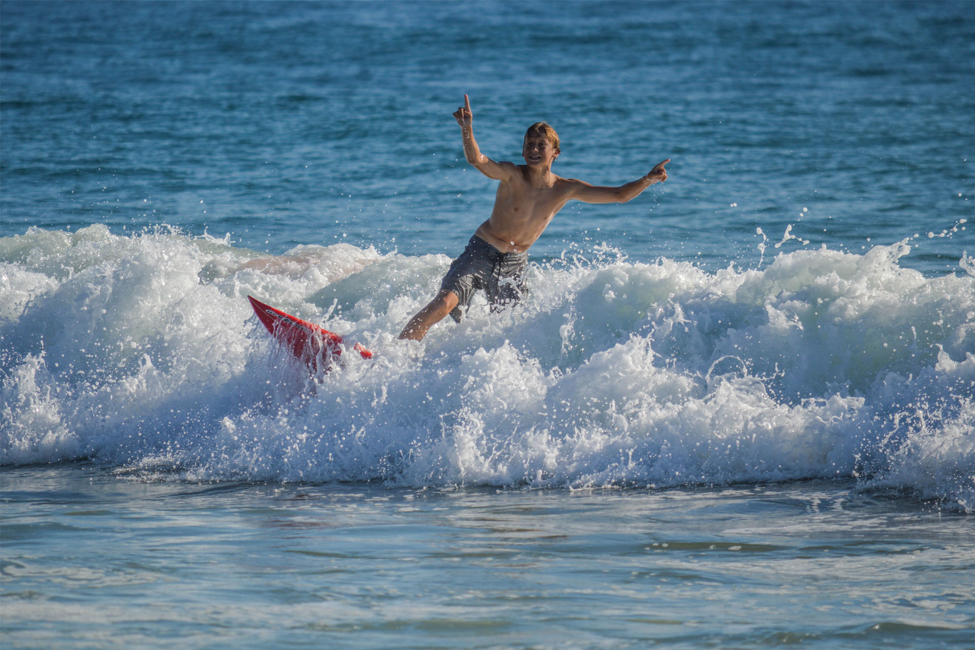 Surfing in Manhattan Beach CA; Courtesy of Lisa Bronitt/Shutterstock.com