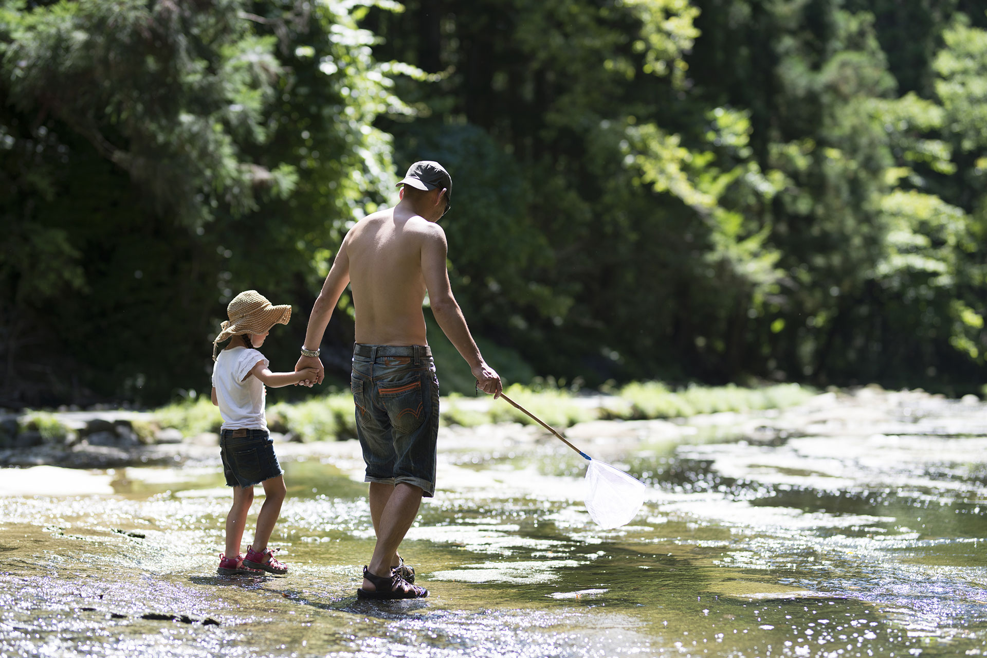 Dad and Daughter Playing in River; Courtesy of Purino/Shutterstock.com