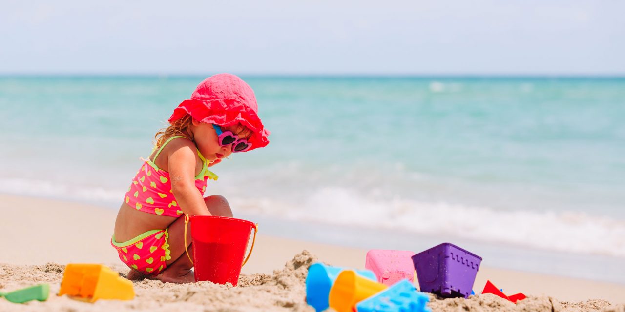 Little Girl Playing on Beach; Courtesy of NadyaEugene/Shutterstock.com