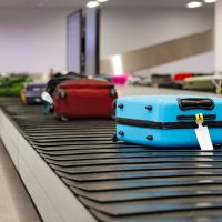 Suitcase or luggage on conveyor belt in the airport waiting