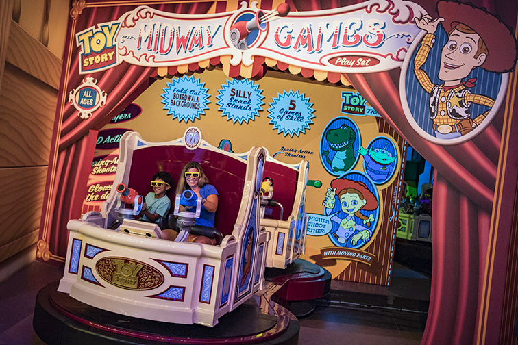 Walt Disney World Resort guests take aim and score big playing the virtual midway games of Toy Story Mania!; Courtesy of Walt Disney World