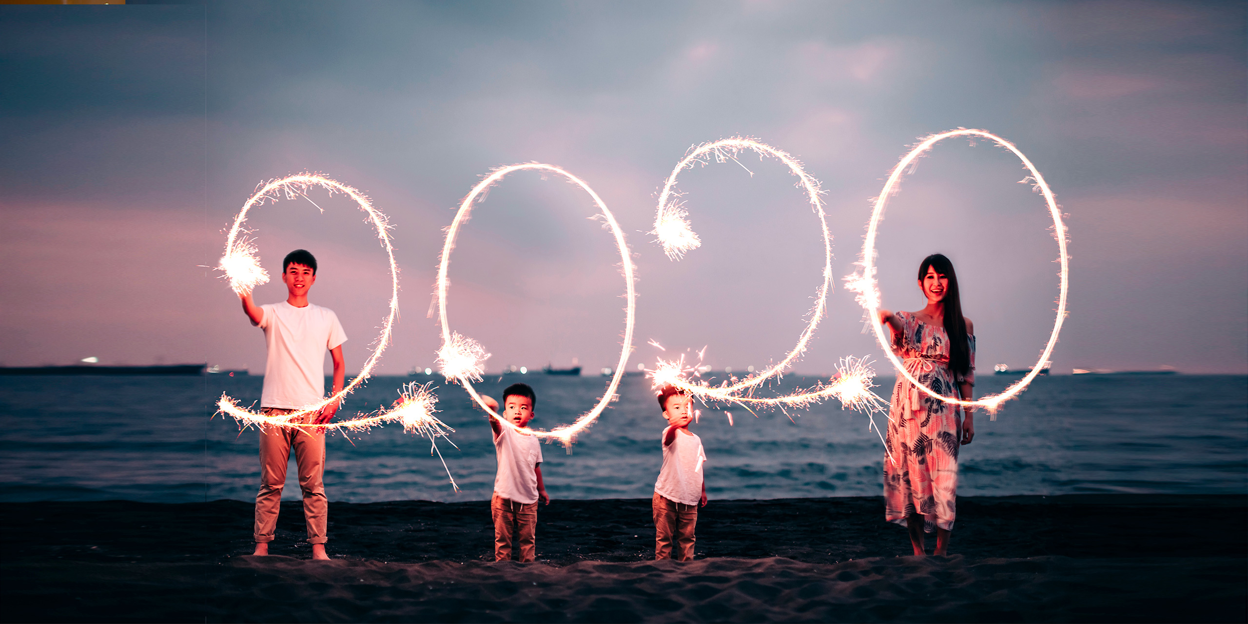 asian family celebrates new years 2020 sparklers; Courtesy of Tom Wang/Shutterstock