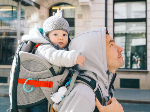 dad walking with a baby in a carrier backpack; Courtesy Natalia Deriabina/Shutterstock
