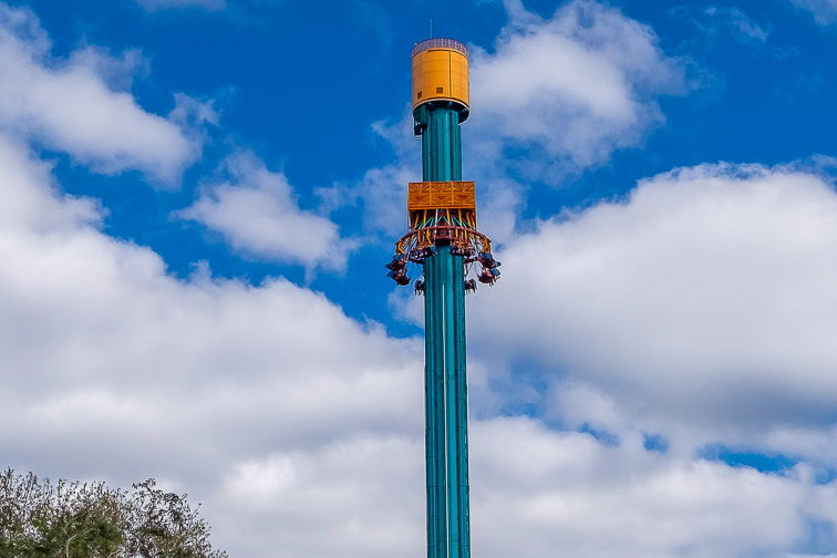 Falcon's Fury Drop Tower in Busch Gardens on a cloudy day with blue sky in the background. The ride has reached the top of the 300 ft tower and has inverted in.
; Courtesy  Dolores M. Harvey/Shutterstock