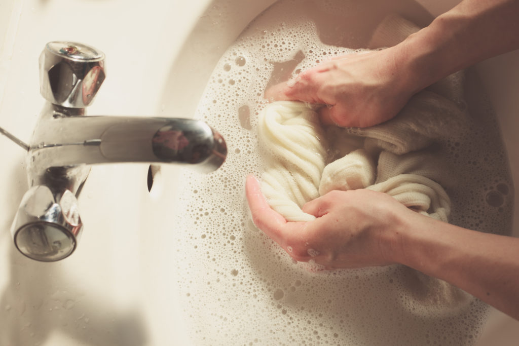 Person washing sock in a sink