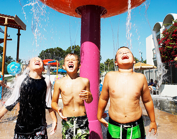 Three children playing in the waterpark at Howard Johnson Anaheim Hotel & Water Playground
