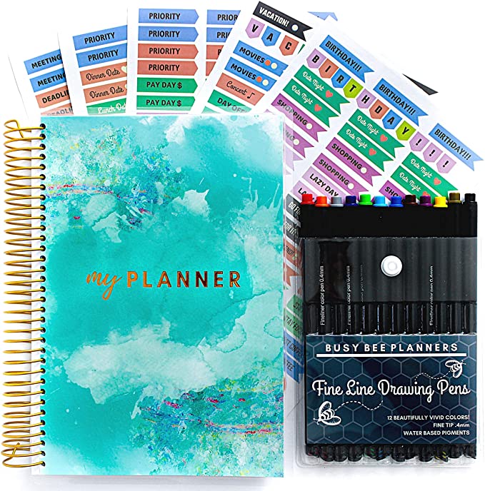 Front cover of the Busy Bee Goals and Gratitude Planner, along with planner stickers and a set of colorful pens