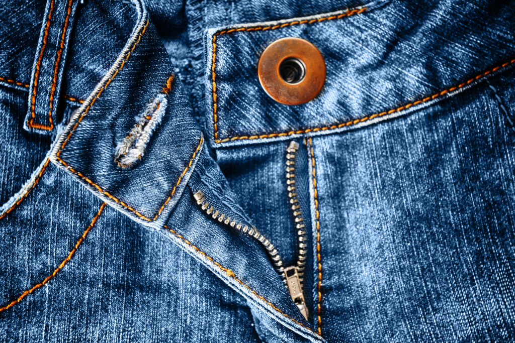 Close up of button closure and zipper on jeans