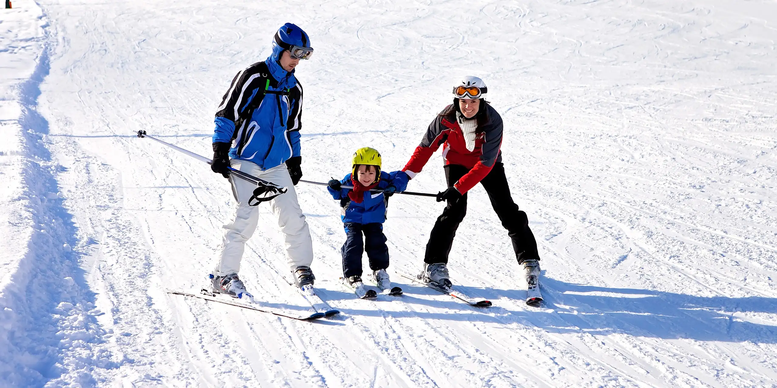 Family learning ski; Courtesy of Tomsickova Tatyana /Shutterstock