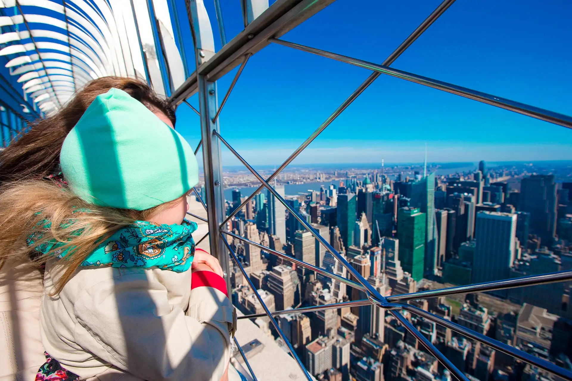 A little girl checking out the view of New York City from the Empire State Building.