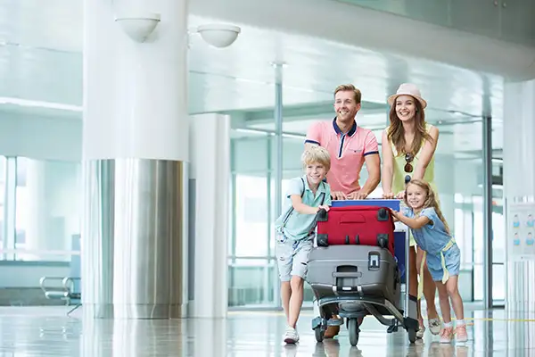 A family of four traveling through the airport