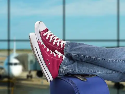 Teenager's Sneakers on Suitcase at Airport; Courtesy of cunaplus/Shutterstock.com