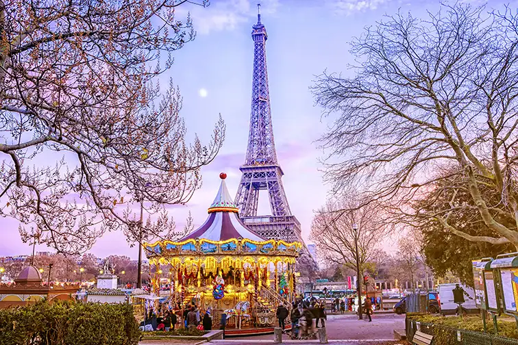 The Eiffel Tower and vintage carousel on a winter evening in Paris; Courtesy of MarinaD_37/Shutterstock