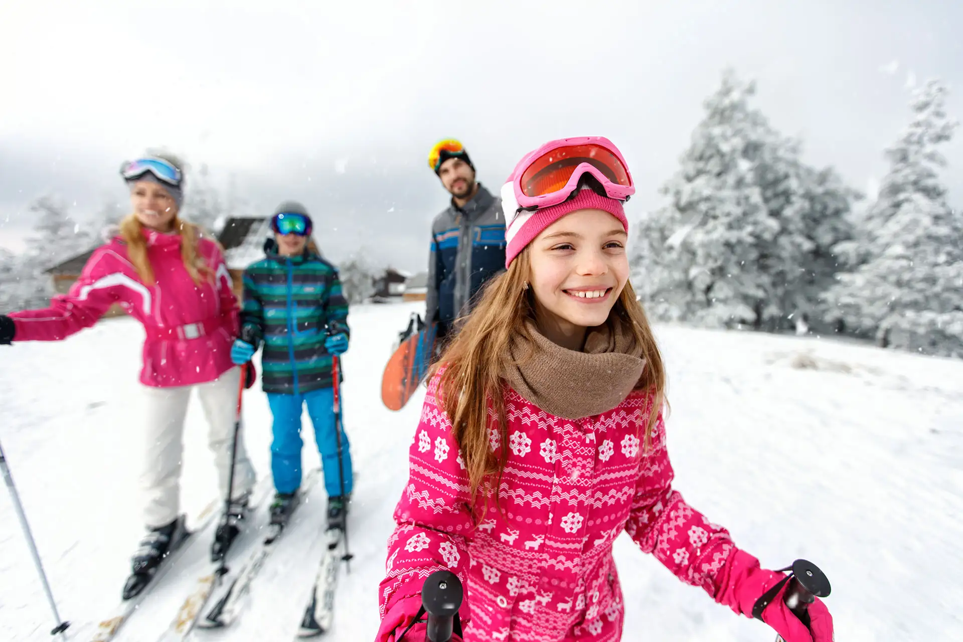 A family skiing.; Courtesy of Lucky Business/Shutterstock.com