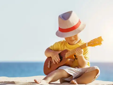 Little Boy Playing Ukulele in Hawaii; Dmitry Molchanov/Shutterstock.com
