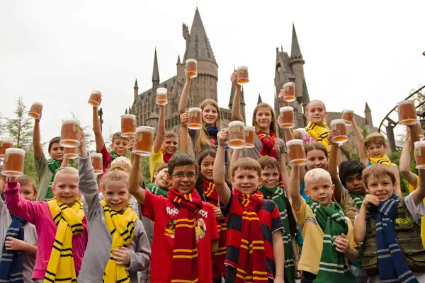 A group of kids drinking butterbeer at The Wizarding World of Harry Potter in Orlando, Florida.