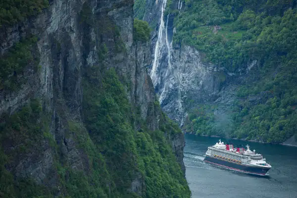 Disney Magic makes its way through the cliffs of Norway.