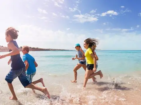 Teens and Tweens Running on Beach; Courtesy of Sergey Novikov/Shutterstock.com