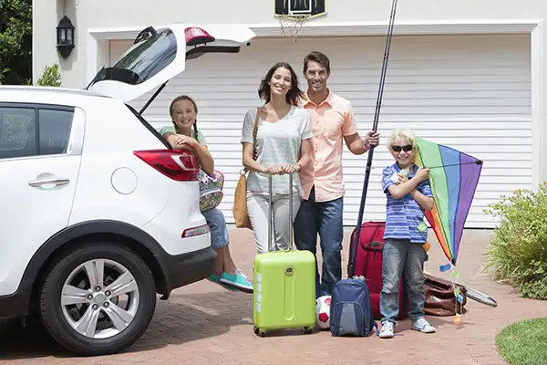 A family packing up their car to head to their vacation rental.