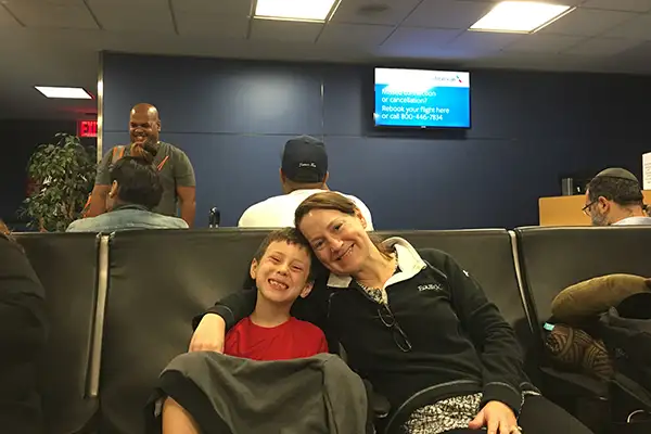 Mother and son waiting to board a plane at the airport.