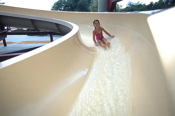A little girl sliding down the waterslide at Rocking Horse Ranch in New York.