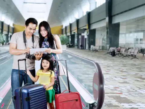 Asian Family at Airport: Courtesy of Creativa Images/Shutterstock.com